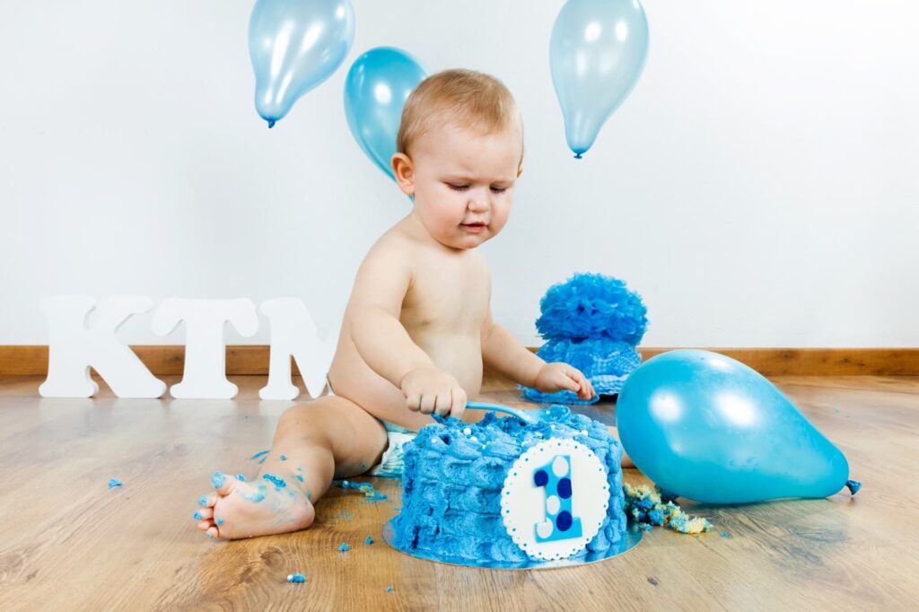 Baby eating birthday cake