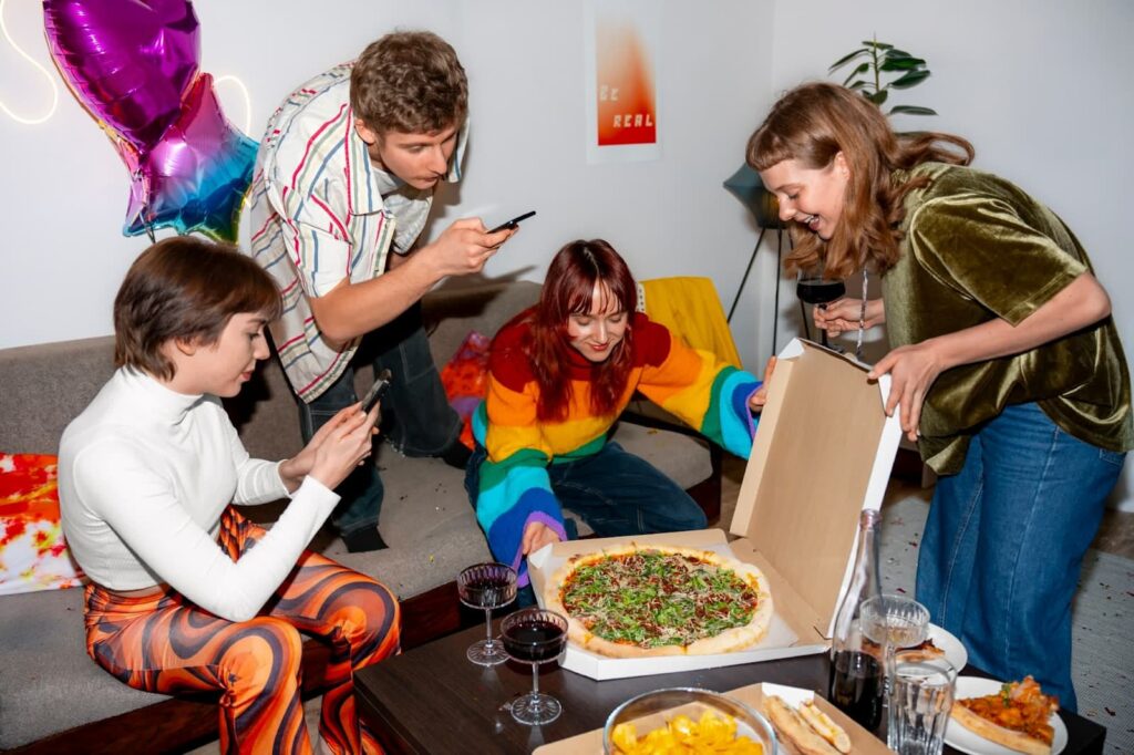 Friends at party with delicious pizza