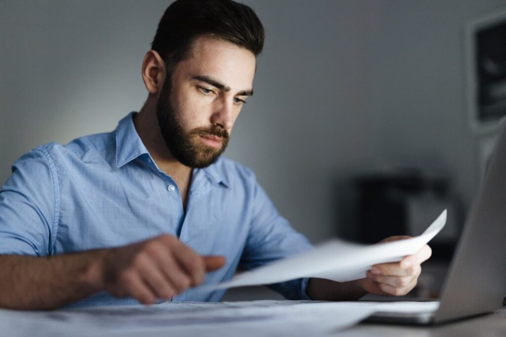 Man looking at documents in the office