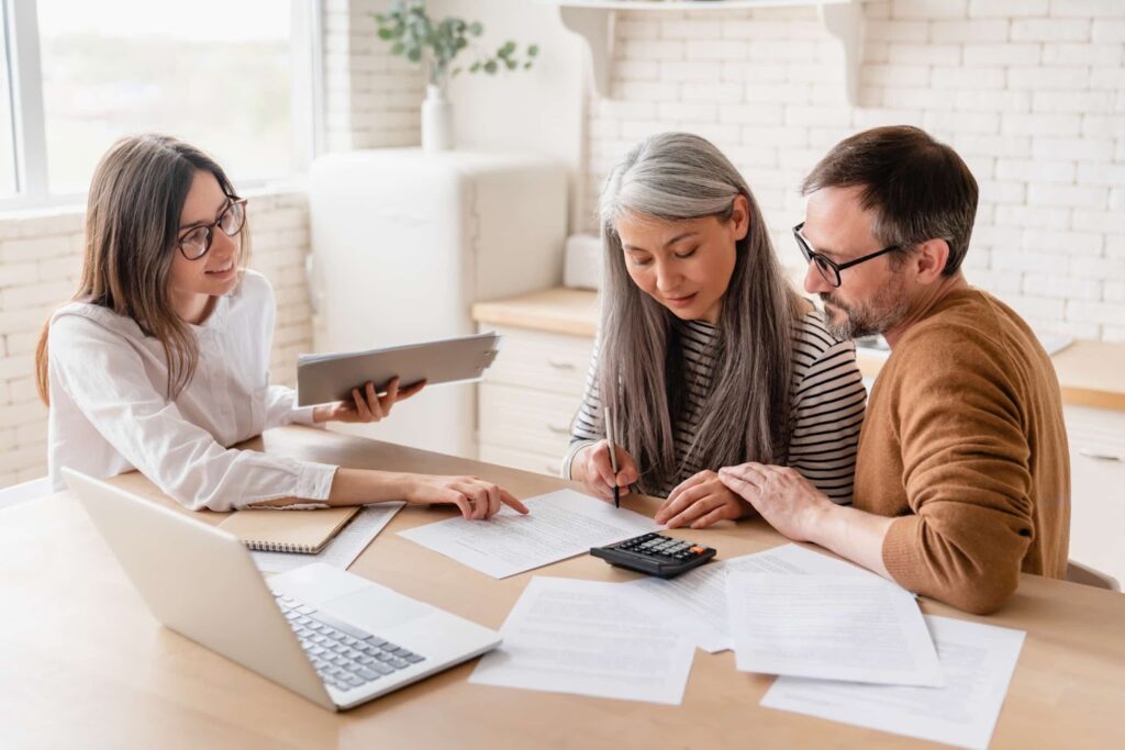 A girl advises a couple about documents